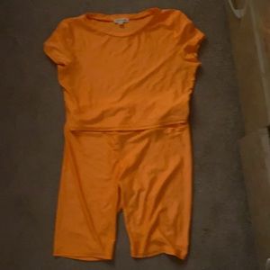 a orange top and orange shorts